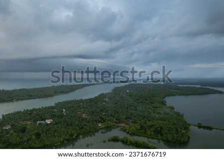 Drone photo of Kavvayi island Kannur Kerala, Awesome river view with coconut trees and beautiful clouds on the background, Kerala travel tourism concept image Royalty-Free Stock Photo #2371676719