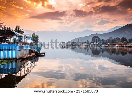 Dal lake view with fantastic reflection of cloudy sky and boathouse
