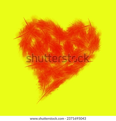 abstract love concept, red birds feathers in the shape of heart on the yellow background