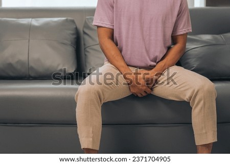 Prostate cancer and men's health, Middle-aged Asian Indian man grappling with testicular discomfort. Vivid portrayal of male health challenges, urging awareness and timely medical consultations. Royalty-Free Stock Photo #2371704905