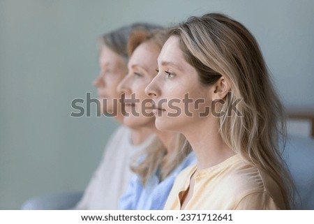 Women of three female family generations side portrait. Serious young adult granddaughter, mature mother, senior grandmother standing in row, line, looking at forward, thinking of dynasty, heredity