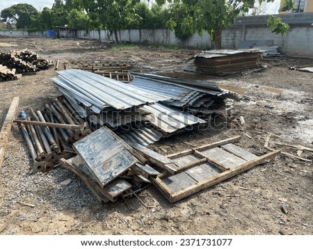 Picture of piles of materials such as steel, zinc, wood on empty land. To prepare for a camp to house workers. in residential construction