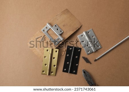 Installation of furniture hinges in chipboard. Small carpentry work in the workshop. light background,Installation of furniture hinges in chipboard in the workshop.dark background
