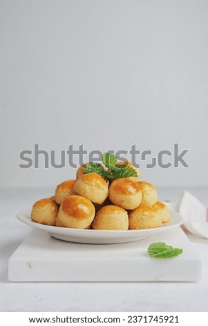 These Pineapple Cookies called Kue Nenas or Nastar in Indonesian, is one of the most popular traditional sweets to celebrate Eid al-Fitri. Selective focus. Royalty-Free Stock Photo #2371745921