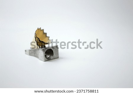 Sharpener and pencil sharpener on a white background. Selective focus.