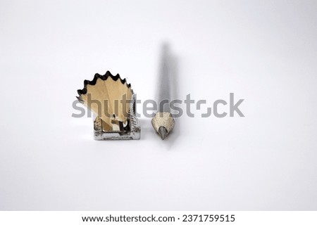 Pencil sharpener and pencil shavings on a white background