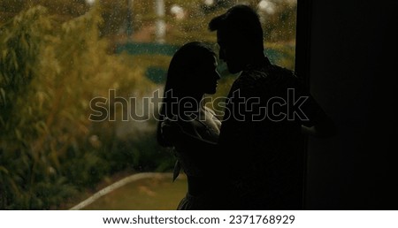 Indian silhouette romantic couple standing close holding hand in dark indoor home enjoy summer vacation. Beautiful smiling girlfriend boyfriend hugging making fun joy together holiday at house Royalty-Free Stock Photo #2371768929
