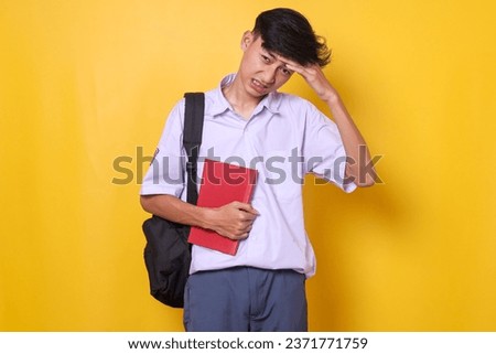 High school student in uniform feeling headache and tired Royalty-Free Stock Photo #2371771759