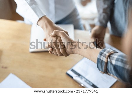 Partners corporate relationship concept. Close up handshake of business people in meeting attendance. Royalty-Free Stock Photo #2371779341