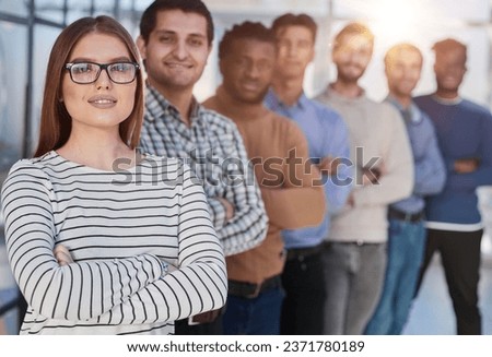 Portrait of multicultural office staff standing in the lobby in a row Royalty-Free Stock Photo #2371780189