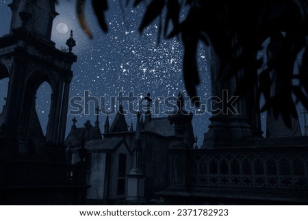 Moonlit old european cemetery in a starry night (stars are from a NASA image)