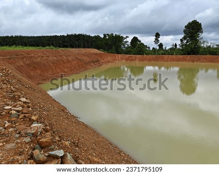 A pond dug for agricultural use  It is a reservoir for farmers to use in the dry season or when there is no rain. It is a well dug by humans.  It contained several bowls of water.