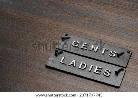 Restroom sign on wooden table
