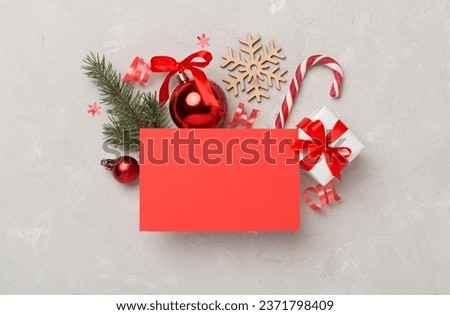 Greeting card mockup with christmas decor on concrete background, top view