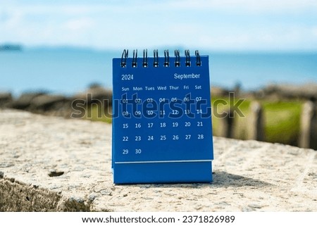 Blue September 2024 calendar on blurred background of blue ocean. 2024 New Year Concept