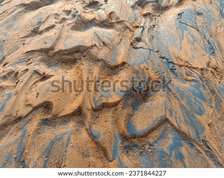 A mesmerizing view of intricate wet river sand patterns, a testament to the artistry of water and earth. Royalty-Free Stock Photo #2371844227