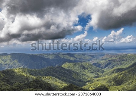 High above the valley of the mountains and canyon in Kauai Hawaii aerial image