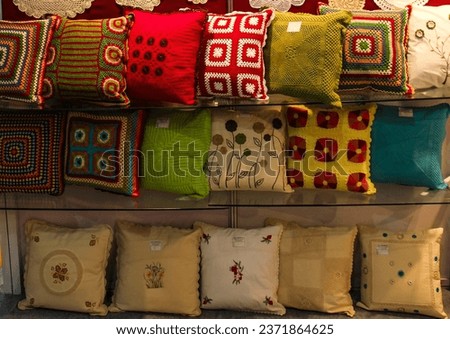 display of handmade colorful crochet cushion and apparels 