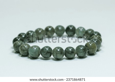 Natural jade gemstone beaded bracelet display on white background Royalty-Free Stock Photo #2371864871