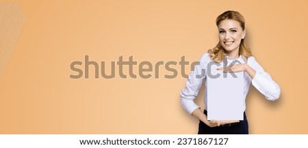 Cheerful smiling business woman in white confident cloth show empty mock up signboard. Success and advertising concept. Copy space place for text brown beige background.dental health care, stomatology