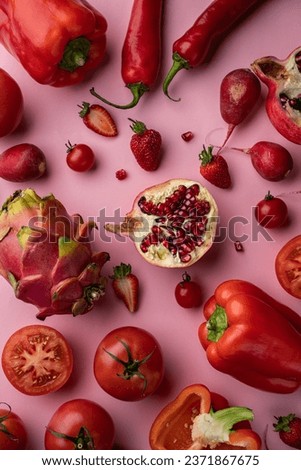 Vibrant green vegetables and fruits showcased on a lush red background, perfect for advertising fresh produce. Healthy and enticing imagery for sale on stock photo platform.