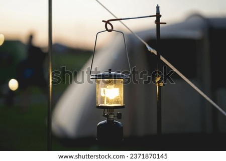 Vintage gasoline lantern that lights with a soft glow. In the dark forest wood light in the dark Holiday camping pictures