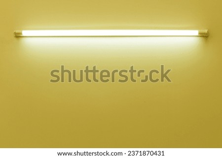 yellow neon lamp on a white wall