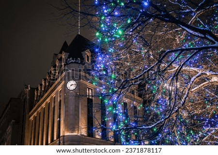 Confederation Square with festive Christmas Lights during winter with Central Post Office clock in the background, corner of Sparks Street and Elgin Street, Ottawa, Ontario, Canada. Photo taken in Dec