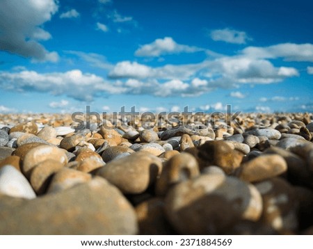 Shallow focus of large stones seen on a deserted beach. The stones are used as part of coastal defences in the east of the UK.