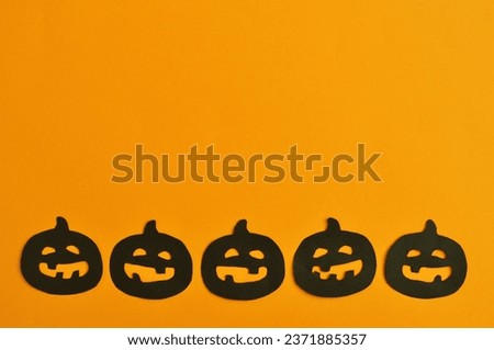 funny Happy Halloween background - pumpkins on the orange background 