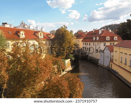 Autumn Landscape of Vltava river in Prague old town with sunset light with medieval buildings