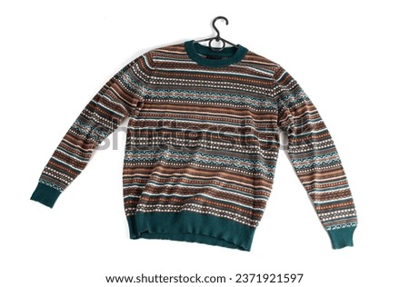 colored sweater with green, orange and brown colors. long sleeve patterned jumper isolated on white background Royalty-Free Stock Photo #2371921597