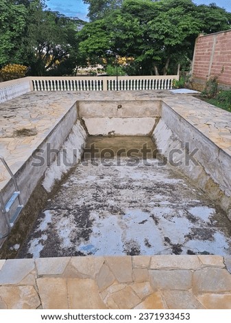 Empty pool, renovation, removal of the vinyl covering from inside the pool.