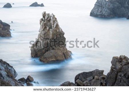 Owl shape rock from Urros de Liencres in Cantabria, Spain. Long exposure picture