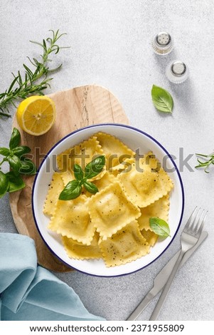 Ravioli with ricotta cheese and fresh basil, top view Royalty-Free Stock Photo #2371955809