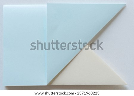 two pieces of card stock paper folded and layered on blank paper Royalty-Free Stock Photo #2371963223