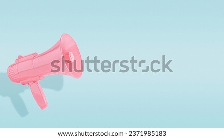 Pink megaphone isolated on a pastel blue background. Creative announcement concept. Advertisement mock up with copy space for text.