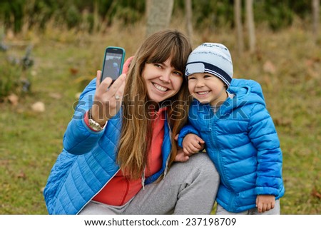 mother and her son outdoors making selfie