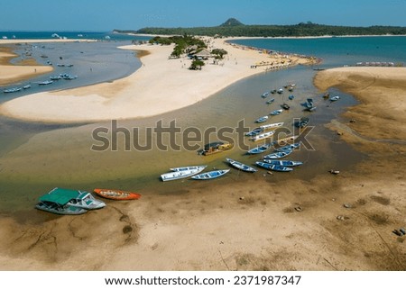 Small boats stranded in the nearly dry bed of the Tapajos river in Alter do Chao, Santarem, Brazil, during the amazonian drought in the second half of 2023 Royalty-Free Stock Photo #2371987347