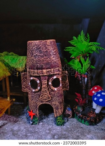 A very realistic decorative statue for an aquarium in the shape of Squidward's house