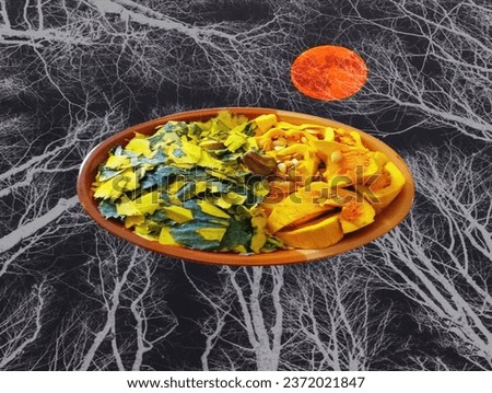 Pictured is a plate of yellow pumpkin seeds and shells decorated with a black forest floor and an orange moon.