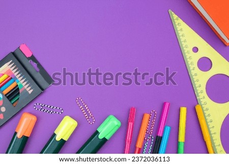 Back to school. Stationery on a Purple table. Office desk with copy space. Flat lay