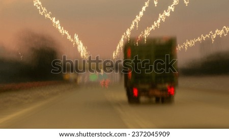 light painting resulting from the movement of a camera installed in a car that is moving on the highway, the image is blurry in the background