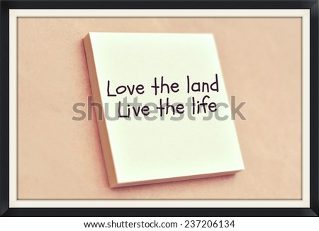 Text live the land live the life on the short note texture background