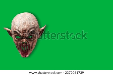 Withered Horror Fleshy Zombie Monster Face Mask Isolated Against green Background, Isolated on green, Halloween theme, copy space, green screen, Sinister Zombie Face Mask: A Spooktacular Halloween 