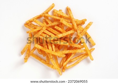 Heap of salted potato sticks on a white background, top view Royalty-Free Stock Photo #2372069055