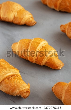 Homemade Croissants on a gray background, side view. 