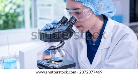 Professional female chemist technician looking microscope research discovery laboratory biotechnology microbiology virus analyzing test, adult woman doctor scientist examining healthcare and medicine