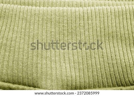 Soft Fabric Green Texture Background. Striped and Flexible Pattern at the Hem of the Shirt, Wrist of the Shirt. Royalty-Free Stock Photo #2372085999