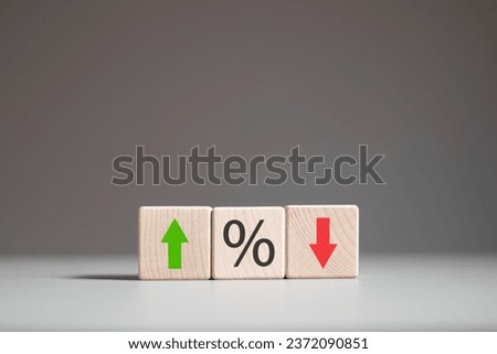 Percentage icon and up and down arrow icon  on wooden block. Changes in interest rate. Financial interest rate and mortgage rate, stock.
